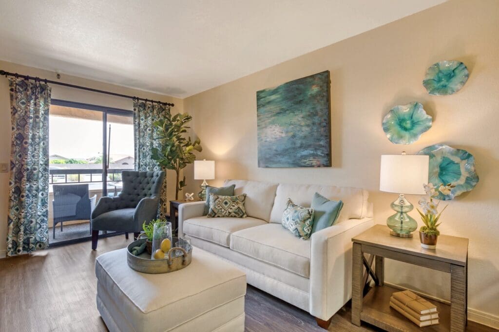 Interior image of a resident's apartment at Inspirations of Mesa with a comfortable couch and beautiful artwork.