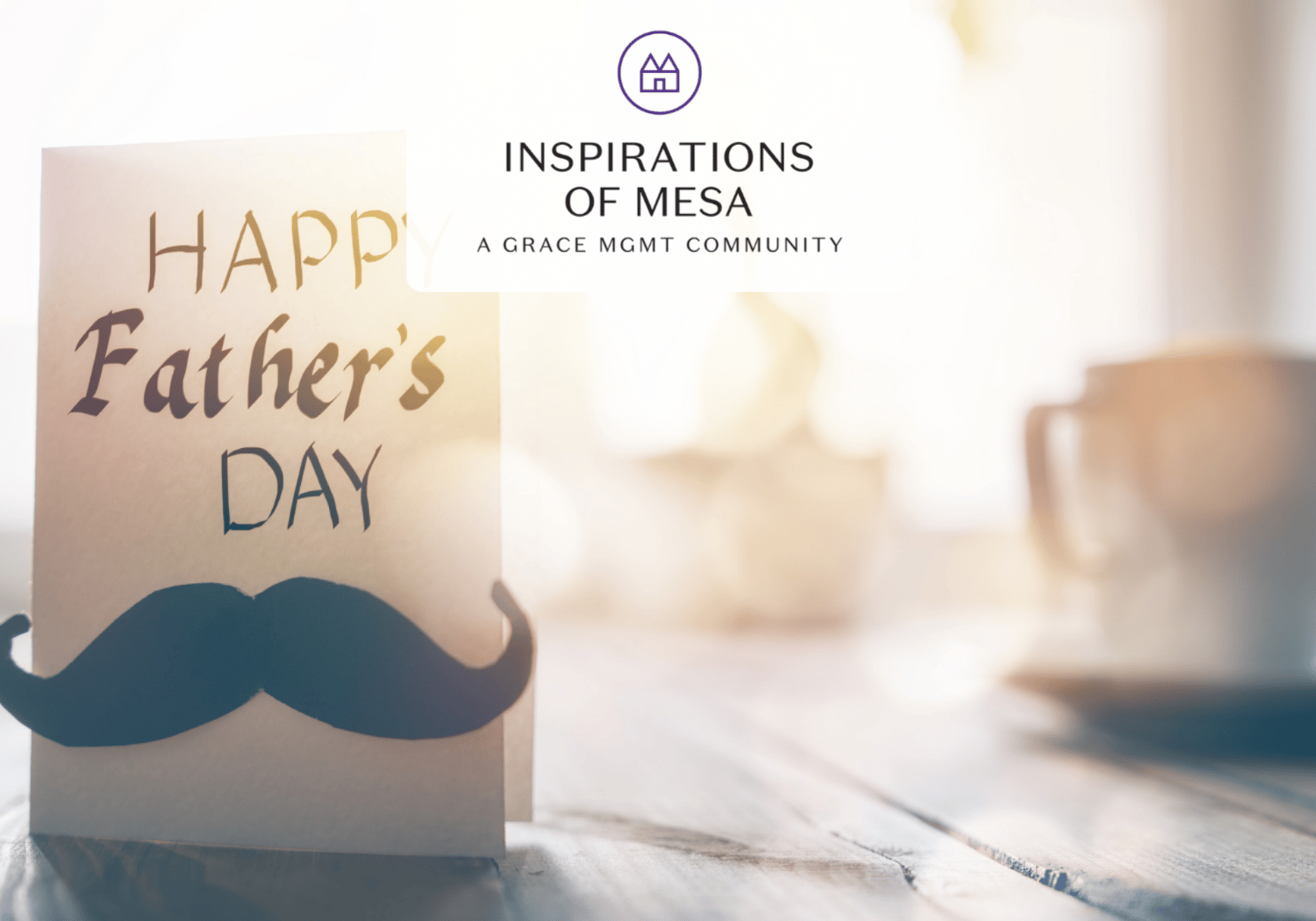 Father's Day card with a blue mustache cutout on a wooden table; blurred coffee mug in the background.